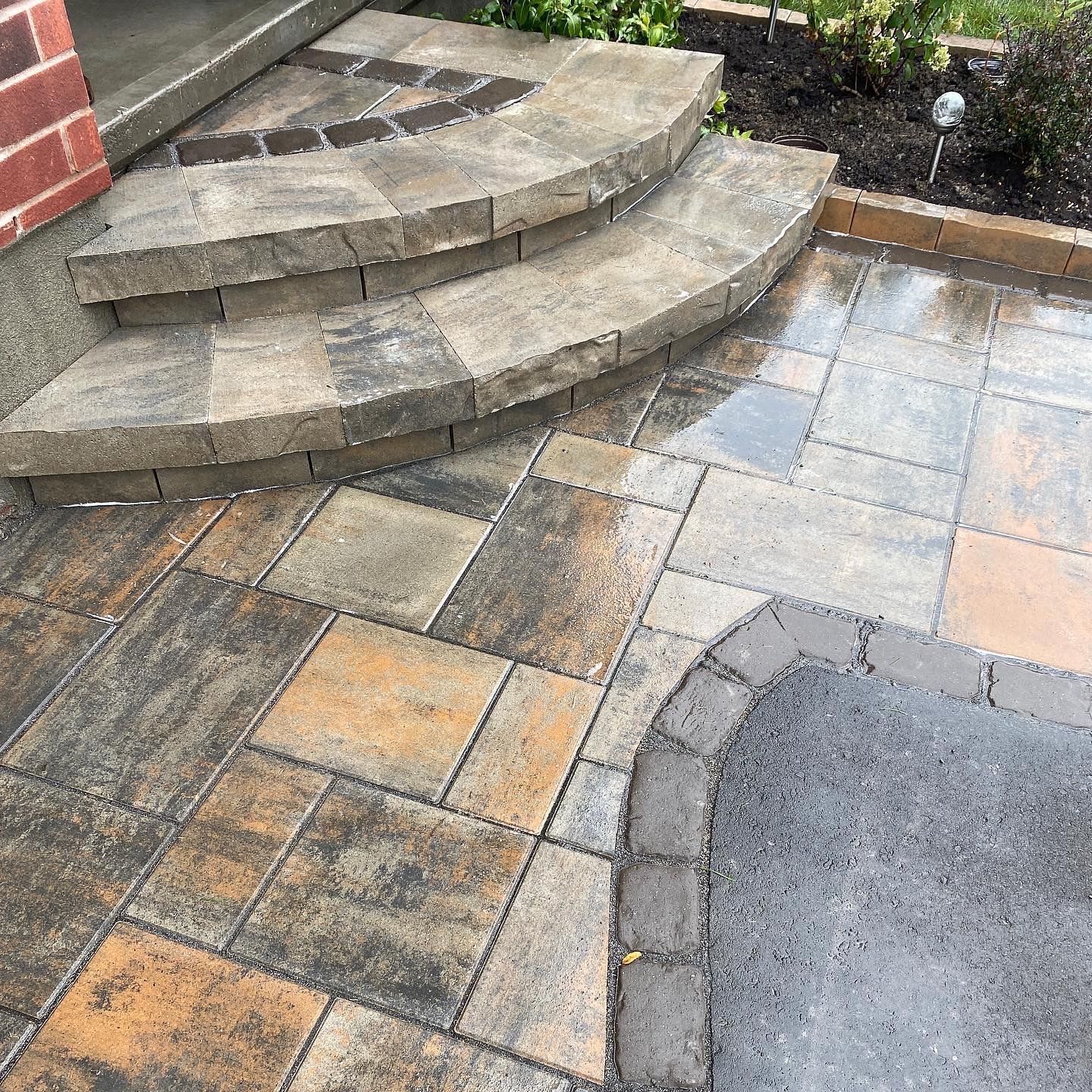 a set of stairs with a brick wall behind them