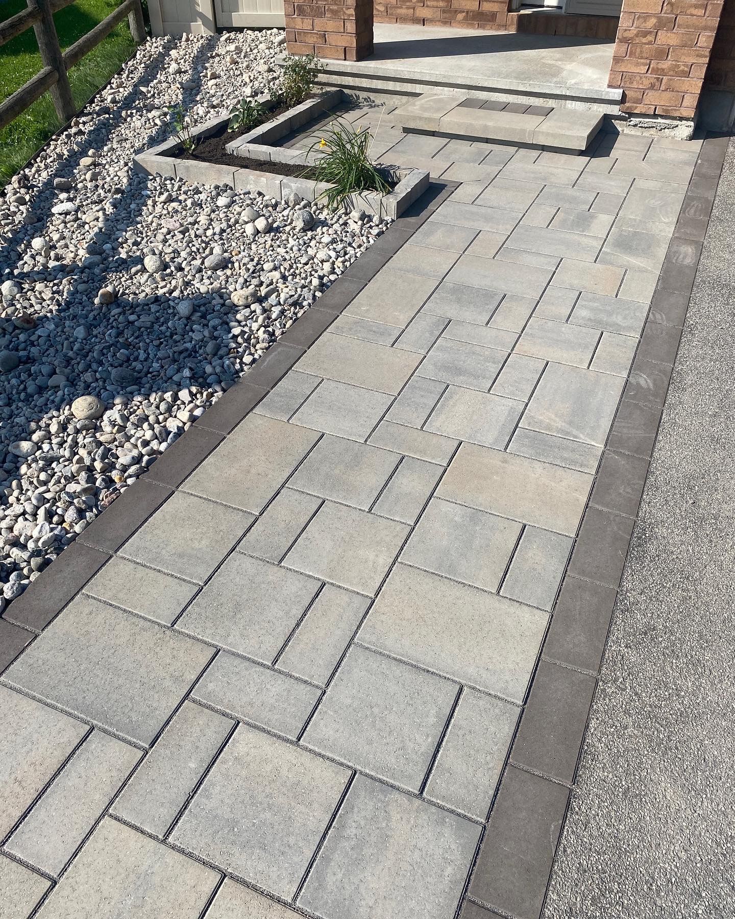 a brick walkway leading to the front door of a house