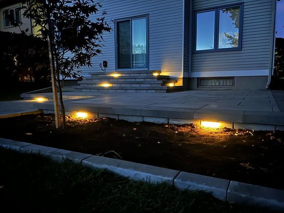 the front of a house is lit up at night