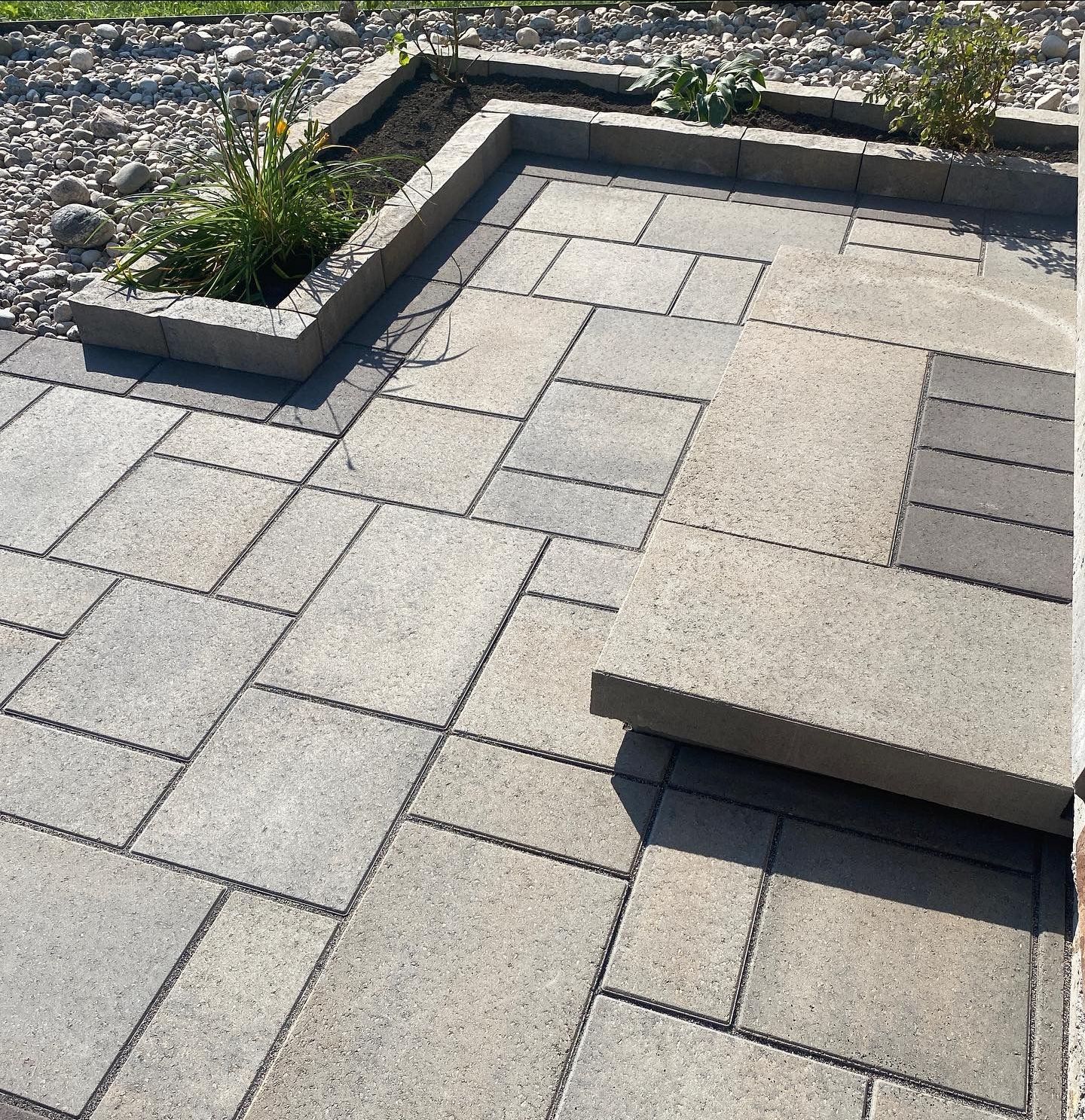a patio with a planter in the middle of it
