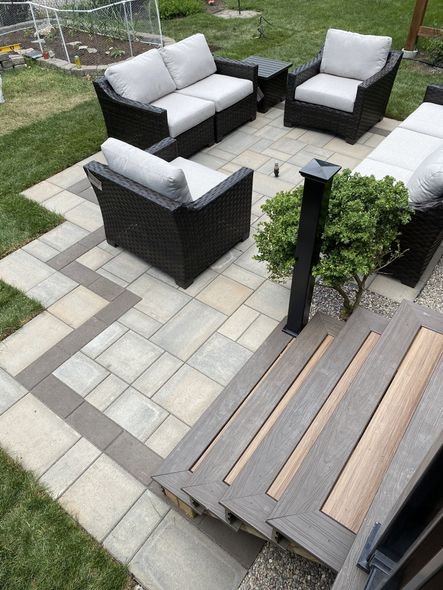 a patio with a couch and chairs on it