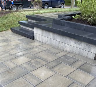 a brick walkway with a truck parked in the background