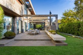 a patio with a table and chairs in the backyard of a house