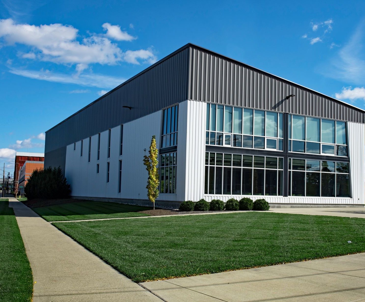 a large building with a lot of windows and a tree in front of it