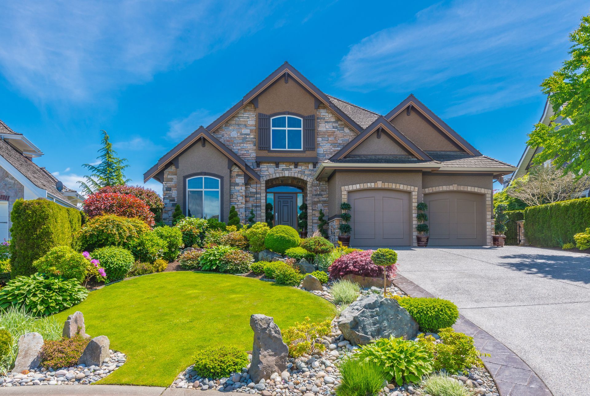 a house with a lush green lawn in front of it