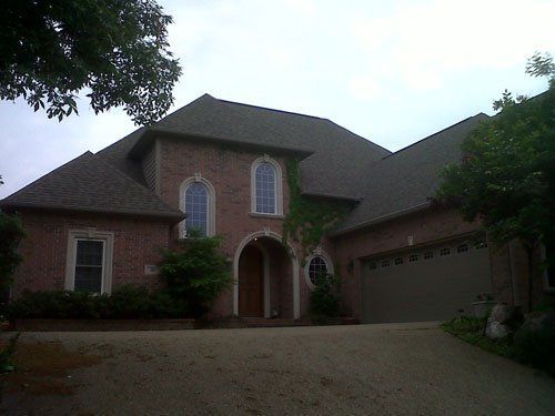 A large brick house with a garage and a driveway