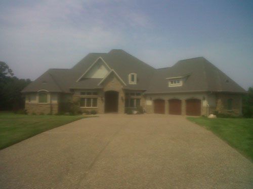 A large house with a driveway leading to it