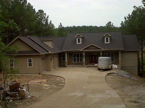 A large house with a trailer parked in front of it