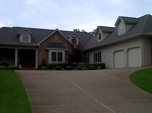 A large house with a driveway leading to it