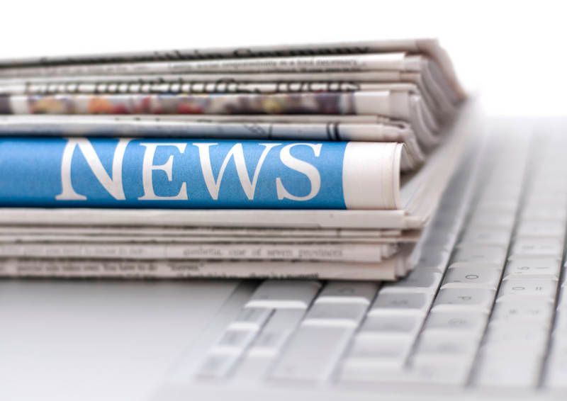 A stack of newspapers with the word news on them