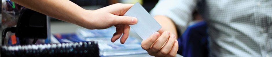 A person is handing a piece of paper to another person.