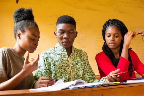 Three youth working together on a project