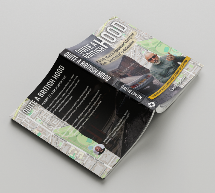 Open book with black and gray pages and a photo on the cover