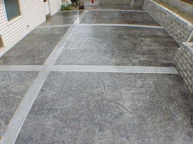 Stamped concrete patio with gray stone pattern and light gray divider lines.
