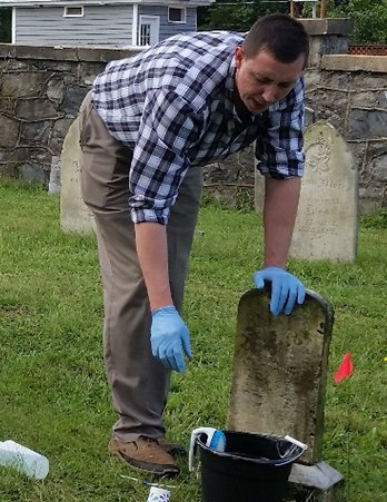 Syntelligent employee working at cemtery