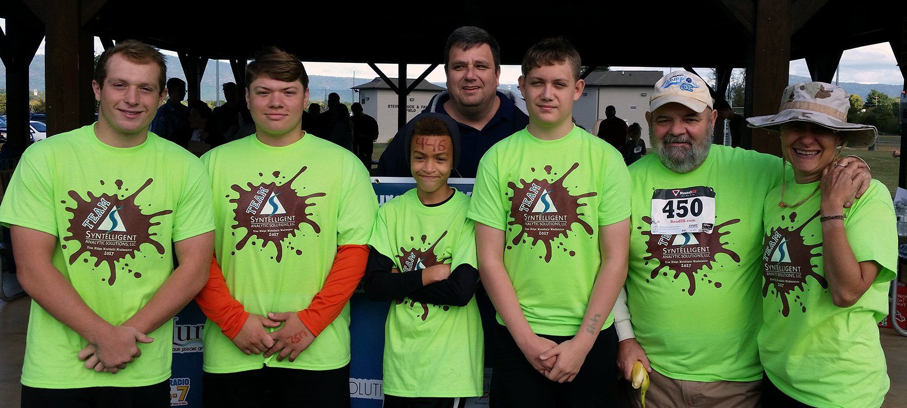 Group photo of Syntelligent employees at Mud Race