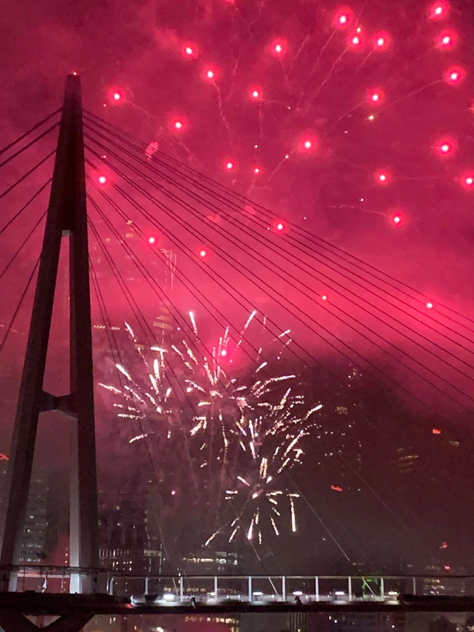 Guests watching spectacular Riverfire fireworks over the Brisbane River from the deck of a private charter boat.
