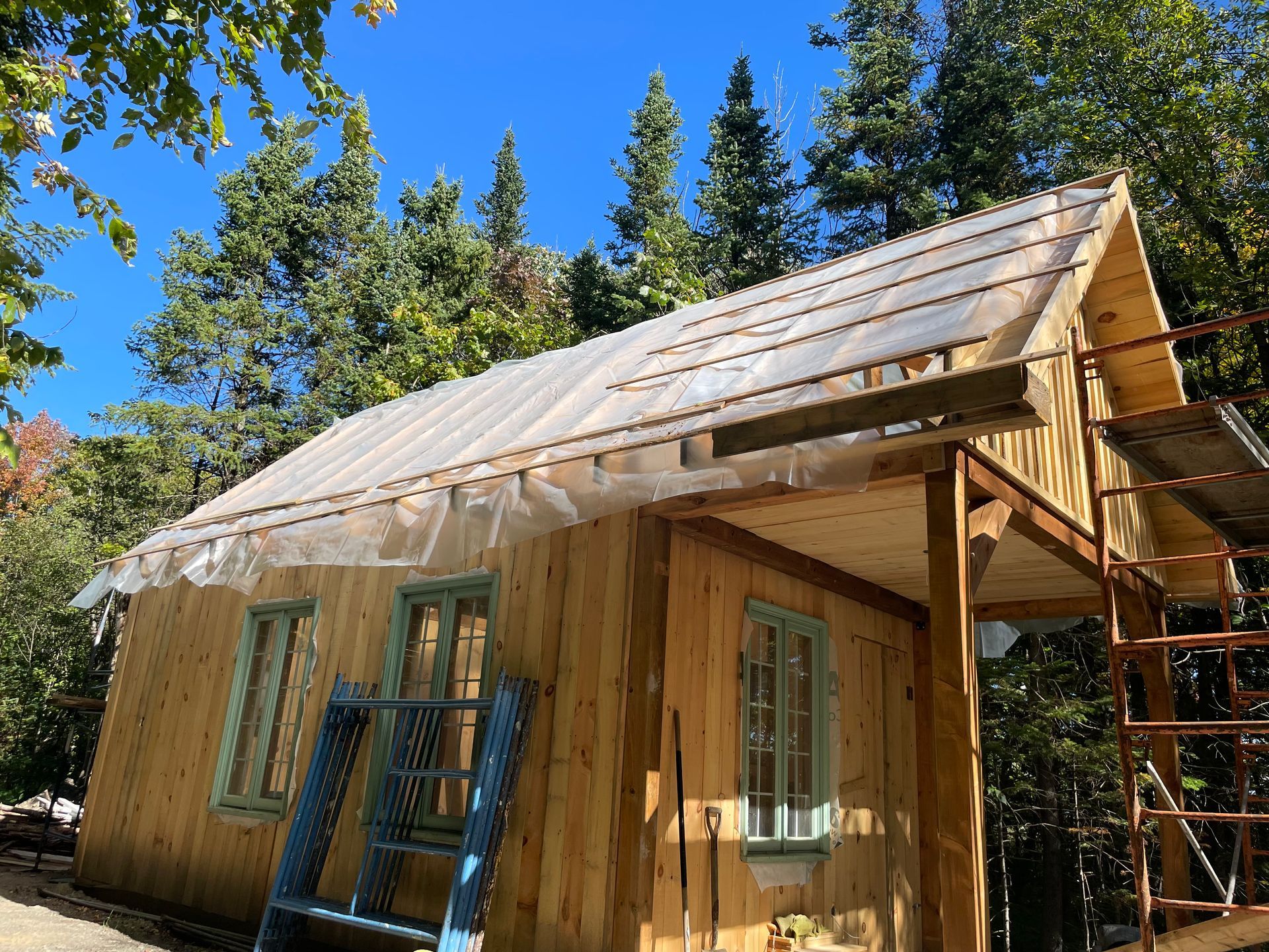 Une petite maison en bois est en construction dans les bois.