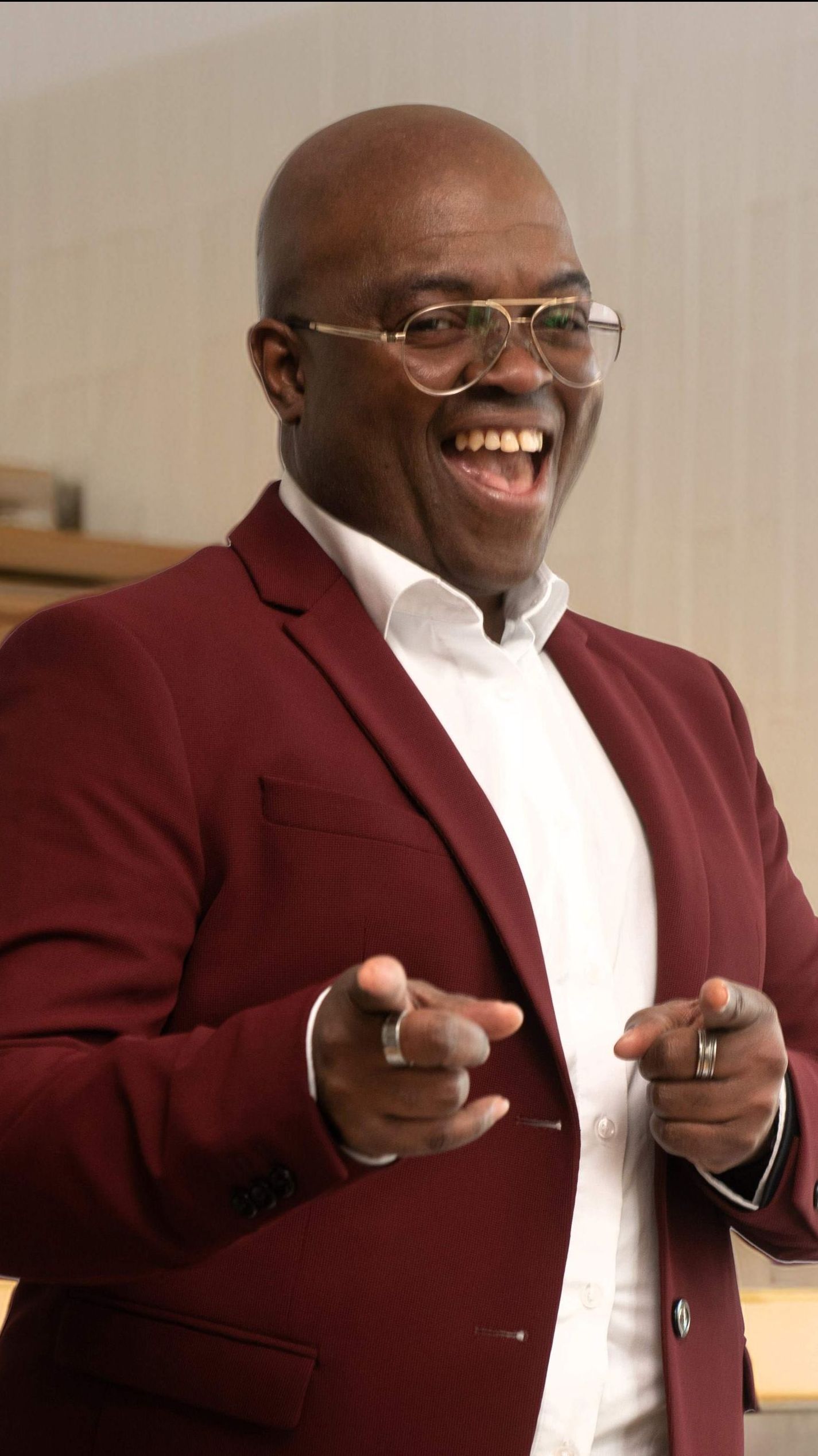 Emile Baars, een zwarte kale man met een bril en een wit overhemd, zingt in een microfoon. Nederlied, Pride Show in Theater Het Zonnehuis in Amsterdam-Noord