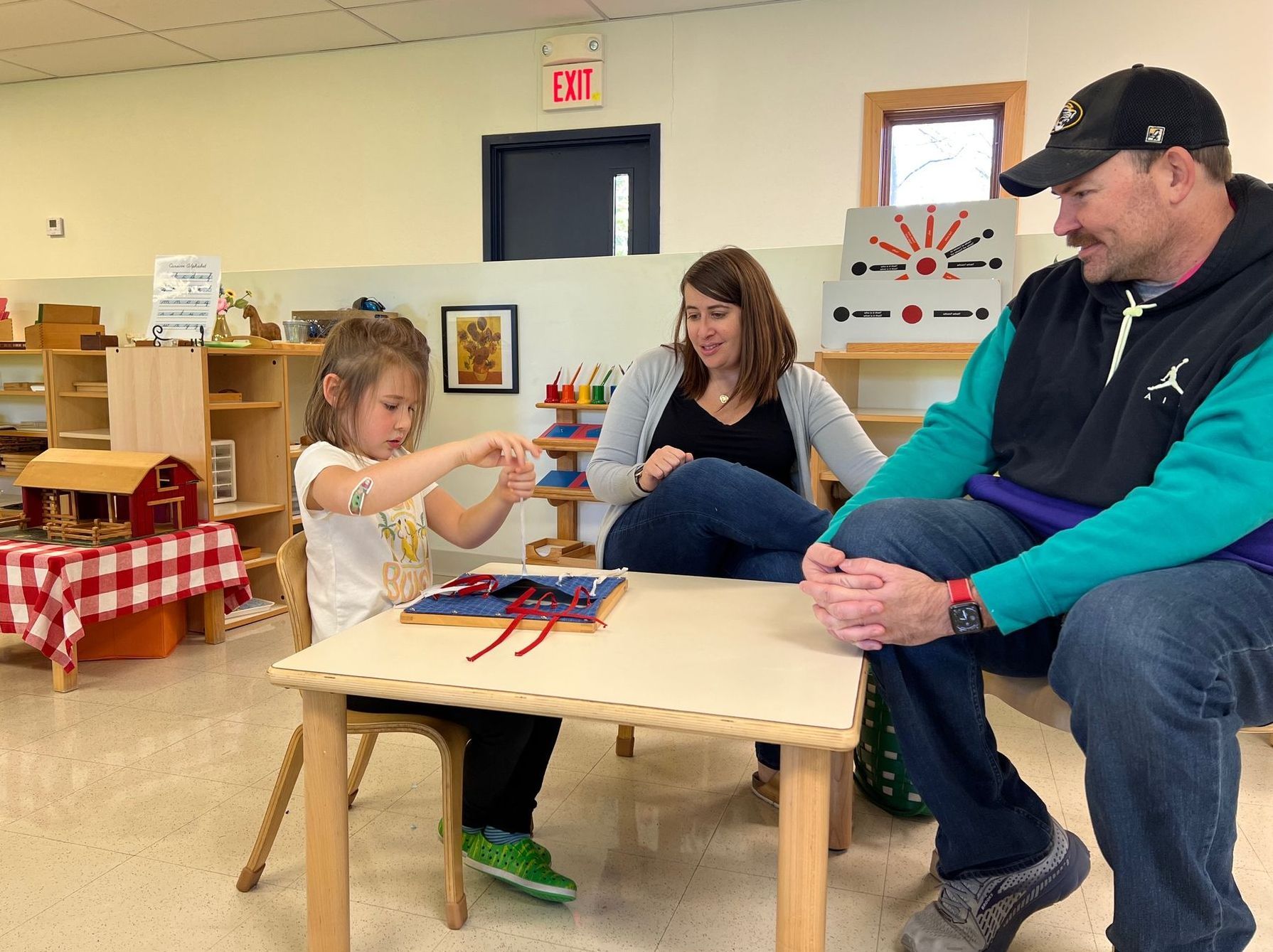 Montessori parents observing their child at work 