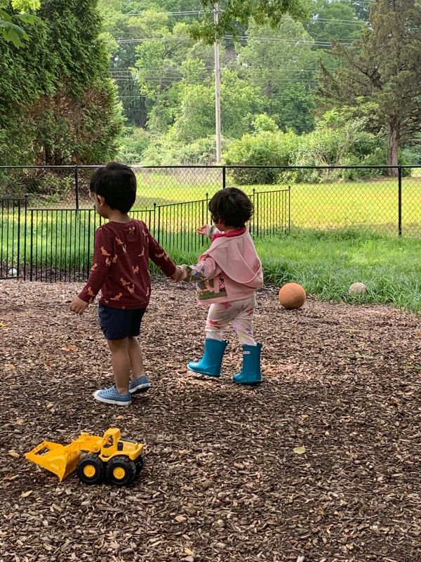 Children holding hands on the playground at Chesterfield Montessori School.