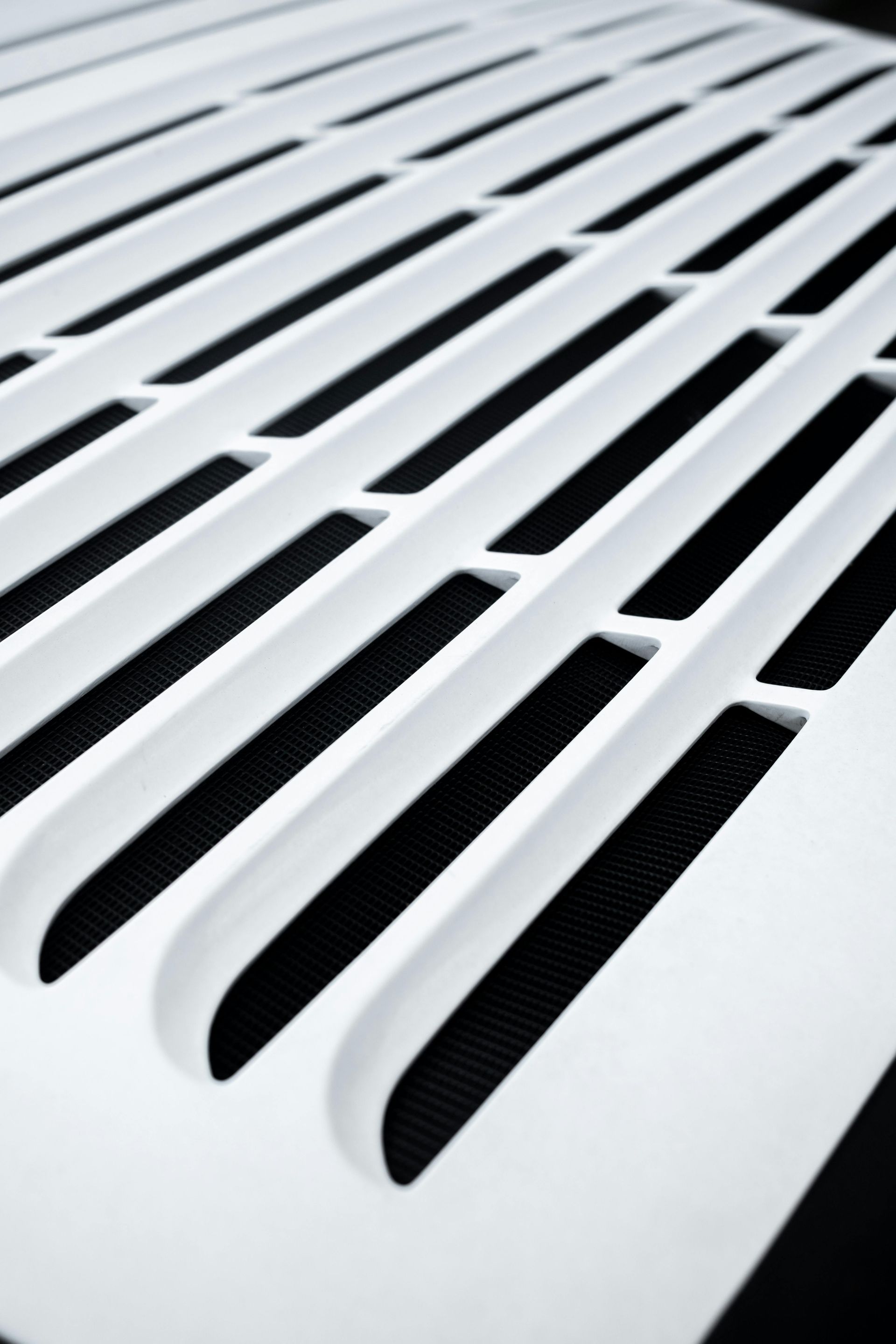 White slatted ventilation grille with dark background.