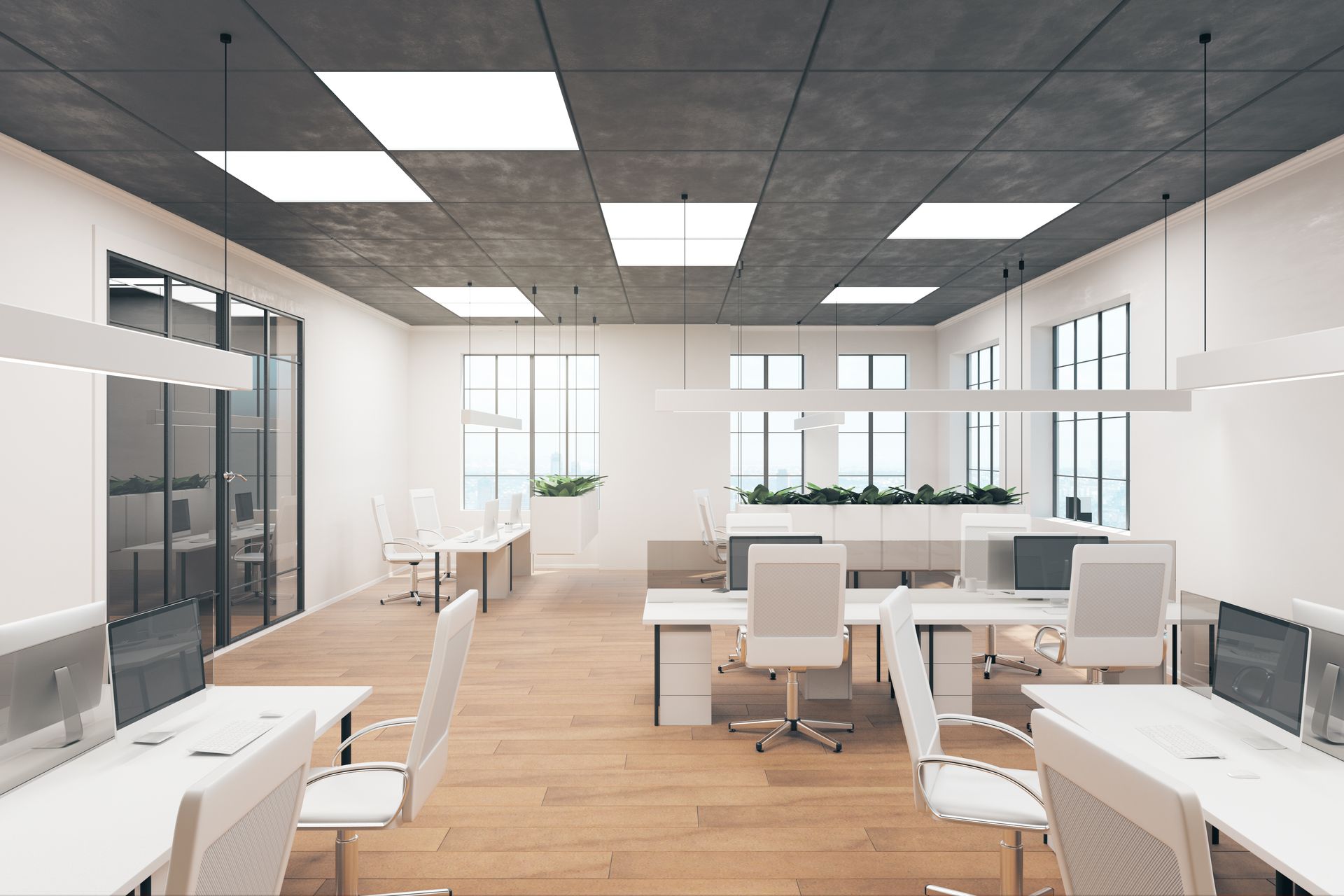 Modern office interior with white desks, chairs, and large windows. Concrete ceiling with bright square lights.