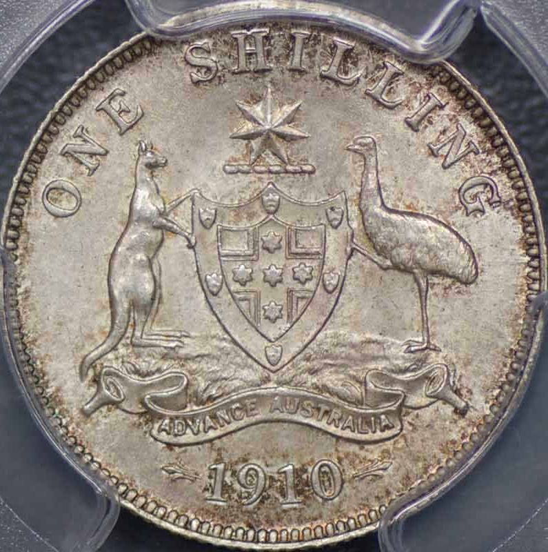 1910 Australian One Shilling silver coin featuring King Edward VII and the Commonwealth coat of arms, obverse and reverse view.