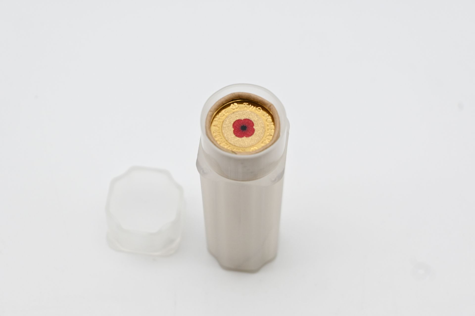 Uncirculated roll of 2012 Red Poppy $2 coins with the coloured poppy coin showing at the open end, Lot 680 at Copeland Roberts Auction 021