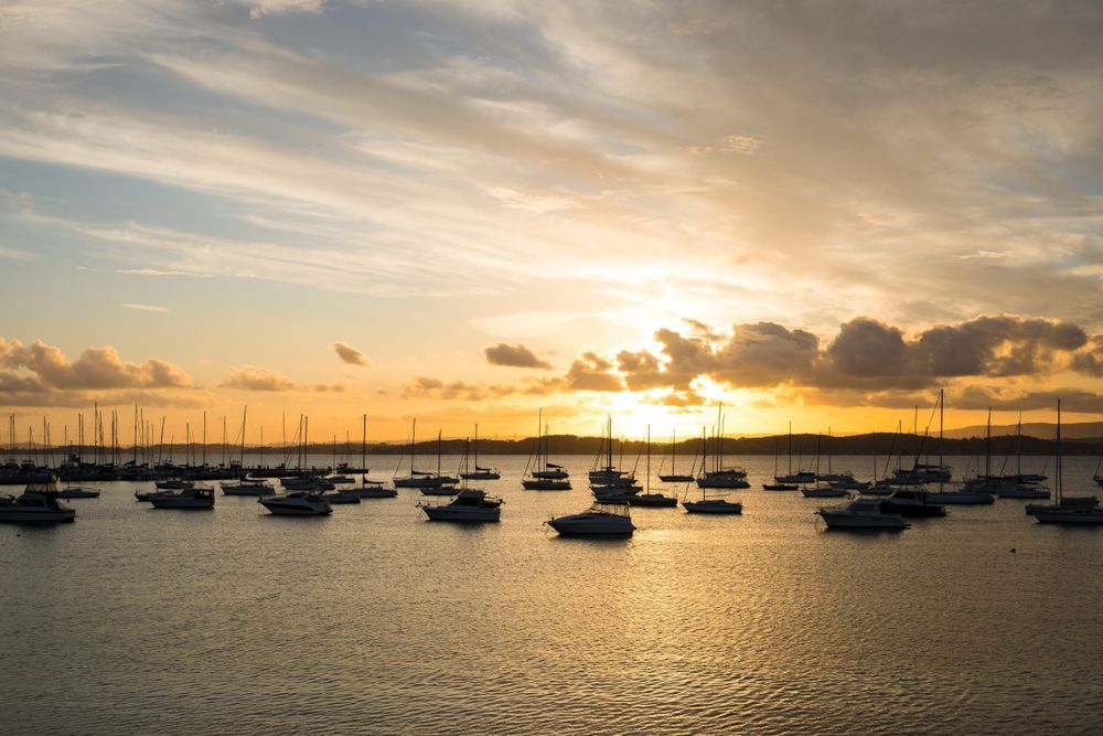 There Are Many Boats in the Water at Sunset — MPE Adventure Quads & Bikes In Lake Macquarie, NSW