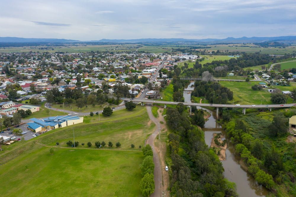 An Aerial View of a Small Town Next to a River and a Bridge — MPE Adventure Quads & Bikes In Singleton, NSW