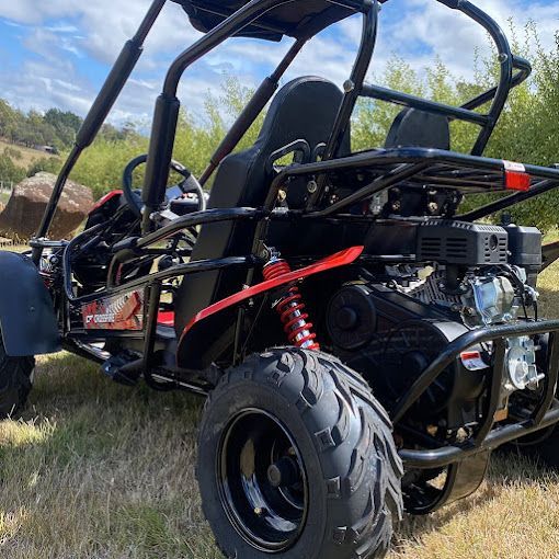 An ATV is parked in the grass in a field — MPE Adventure Quads & Bikes In Muswellbrook, NSW