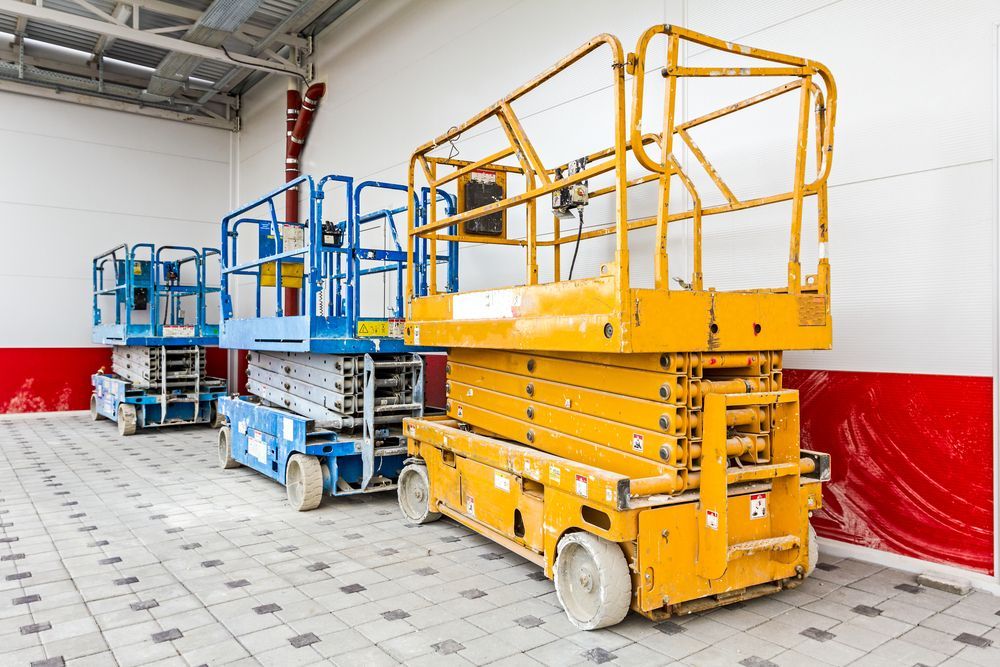 A Row of Scissor Lifts Are Parked in a Warehouse — MPE Adventure Quads & Bikes In Taree, NSW