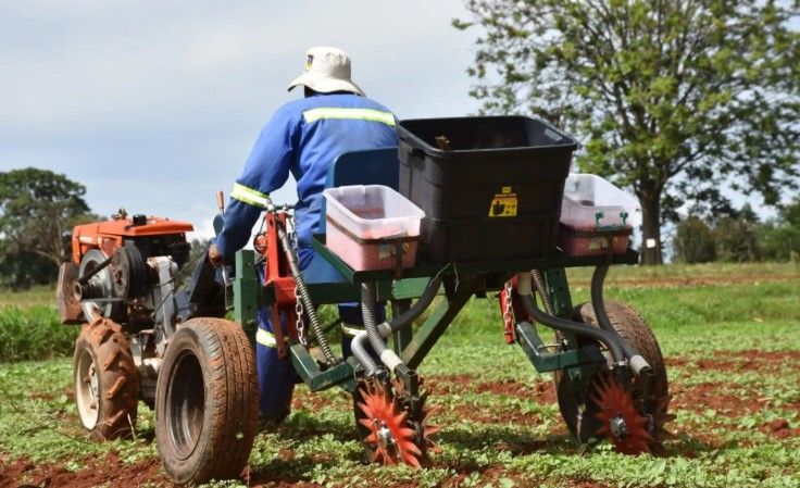 A man is driving a tractor in a field — MPE Adventure Quads & Bikes In Lake Macquarie, NSW