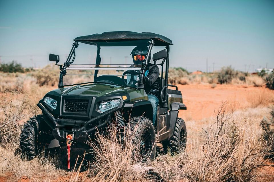 A man is riding a green atv on a dirt road — MPE Adventure Quads & Bikes In Thornton, NSW
