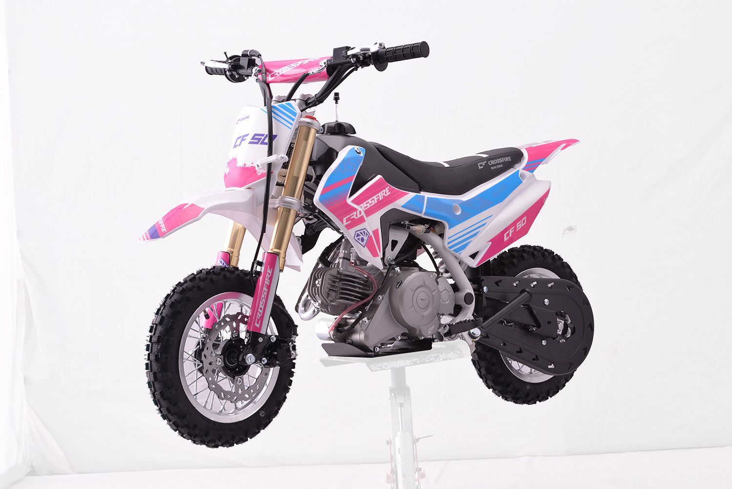 A Pink and Blue Dirt Bike is Sitting on Top of a White Table — MPE Adventure Quads & Bikes In Cessnock, NSW