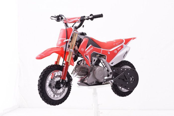 A Red Dirt Bike is Sitting on Top of a White Table — MPE Adventure Quads & Bikes In Muswellbrook, NSW