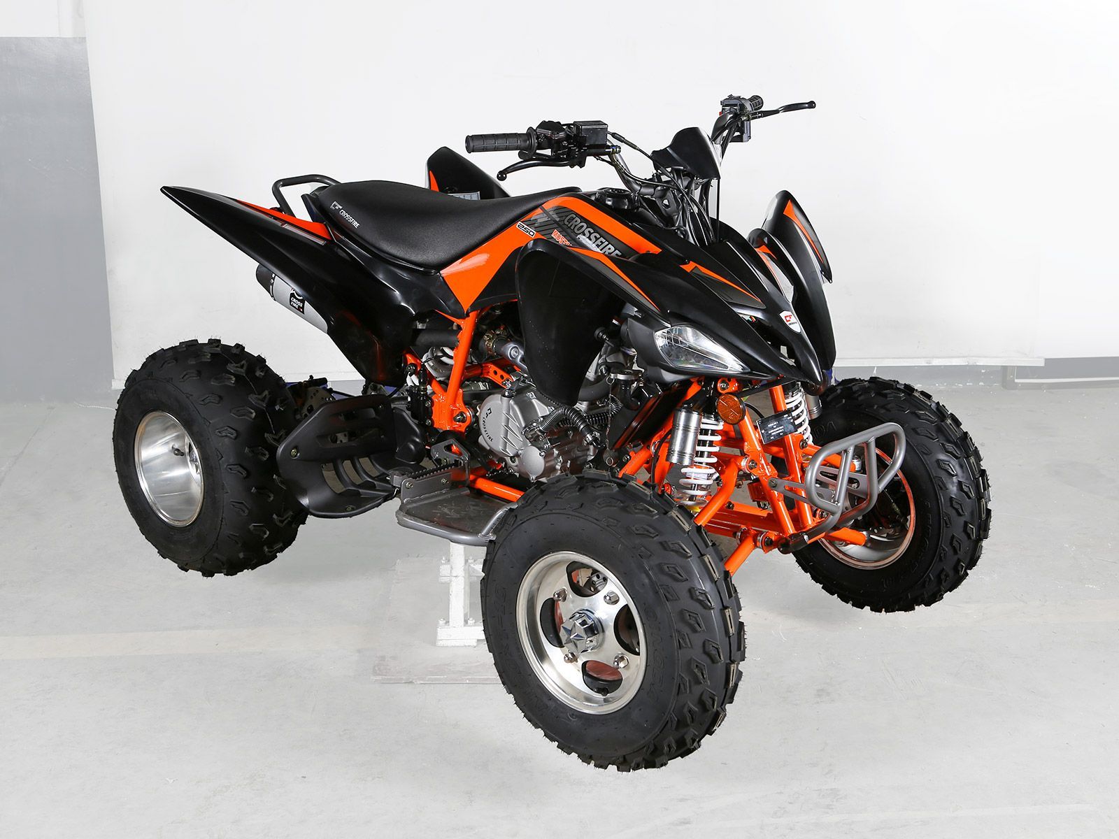 A Black and Orange ATV is on a White Background — MPE Adventure Quads & Bikes In Cessnock, NSW