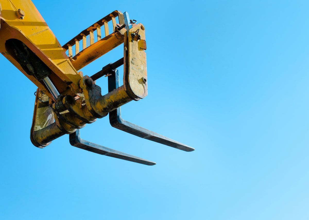 A Close Up of a Yellow Forklift Against a Blue Sky — MPE Adventure Quads & Bikes In Singleton, NSW