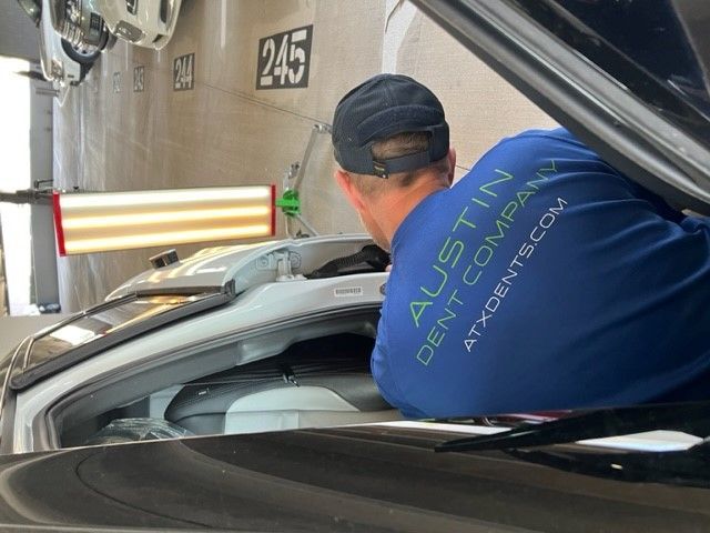 An Austin Dent Company expert repairs small door ding damage in Leander Texas