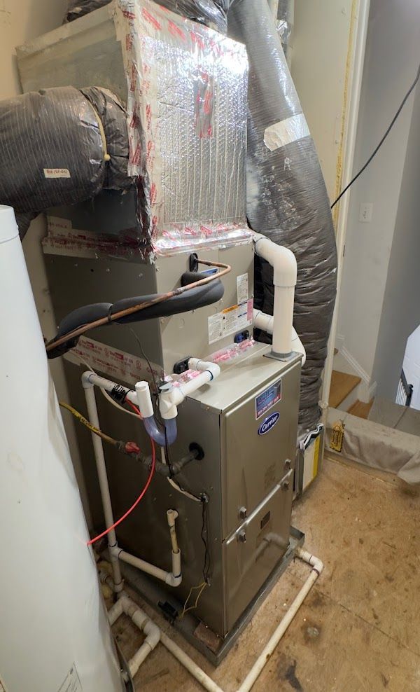 Carrier HVAC installation with ducting and PVC drainage by Alex HVAC Service LLC