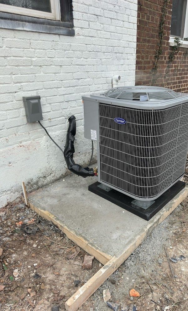 Carrier air conditioning installation on concrete pad by Alex HVAC Service LLC