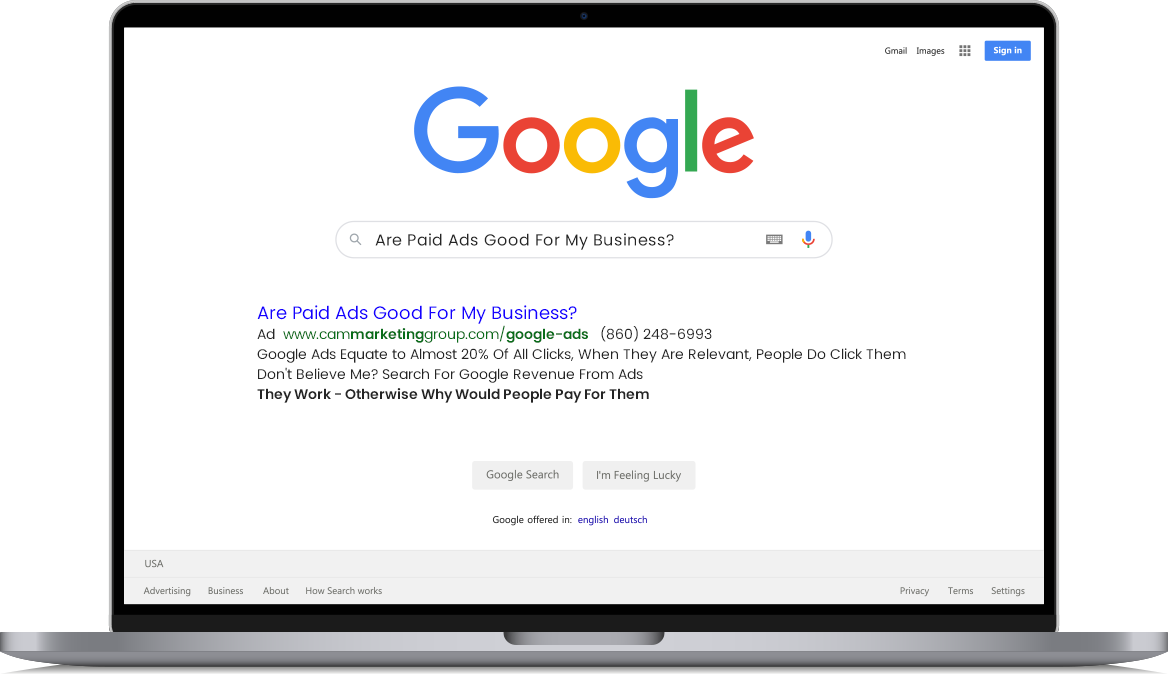 A laptop computer is open to a google search page.