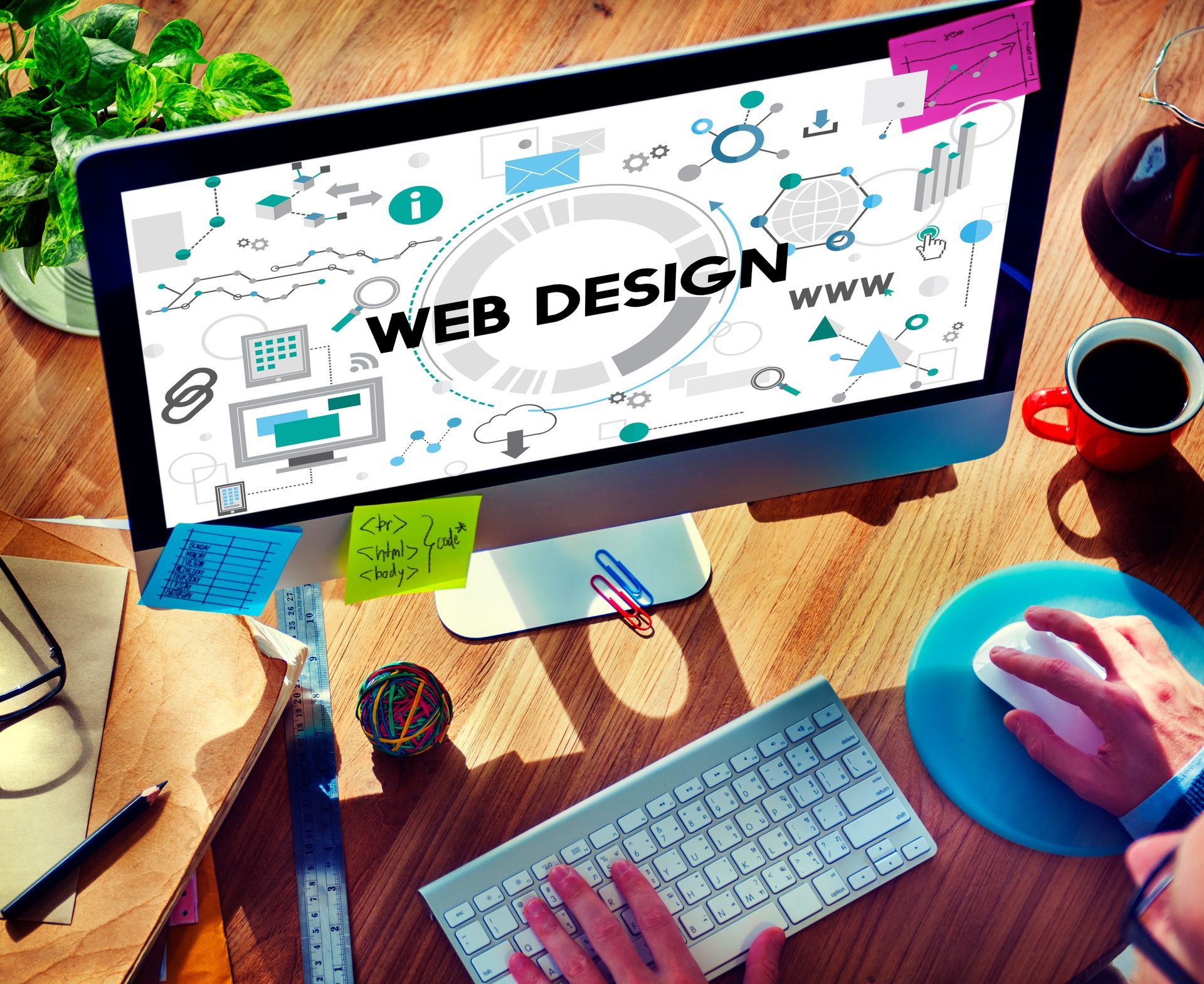 A person is typing on a computer with the words web design on the screen