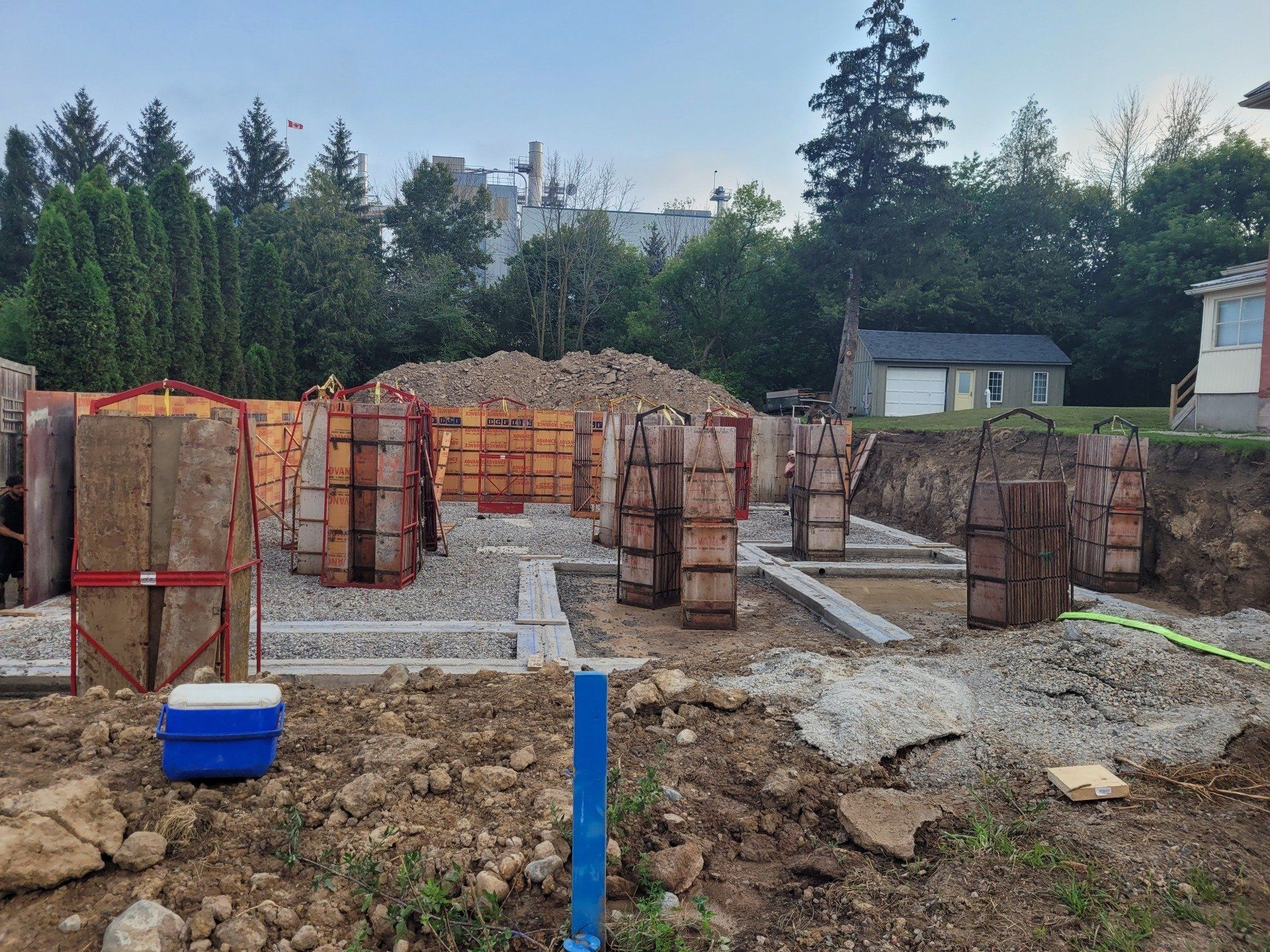 A construction site with a blue cooler in the middle of it.