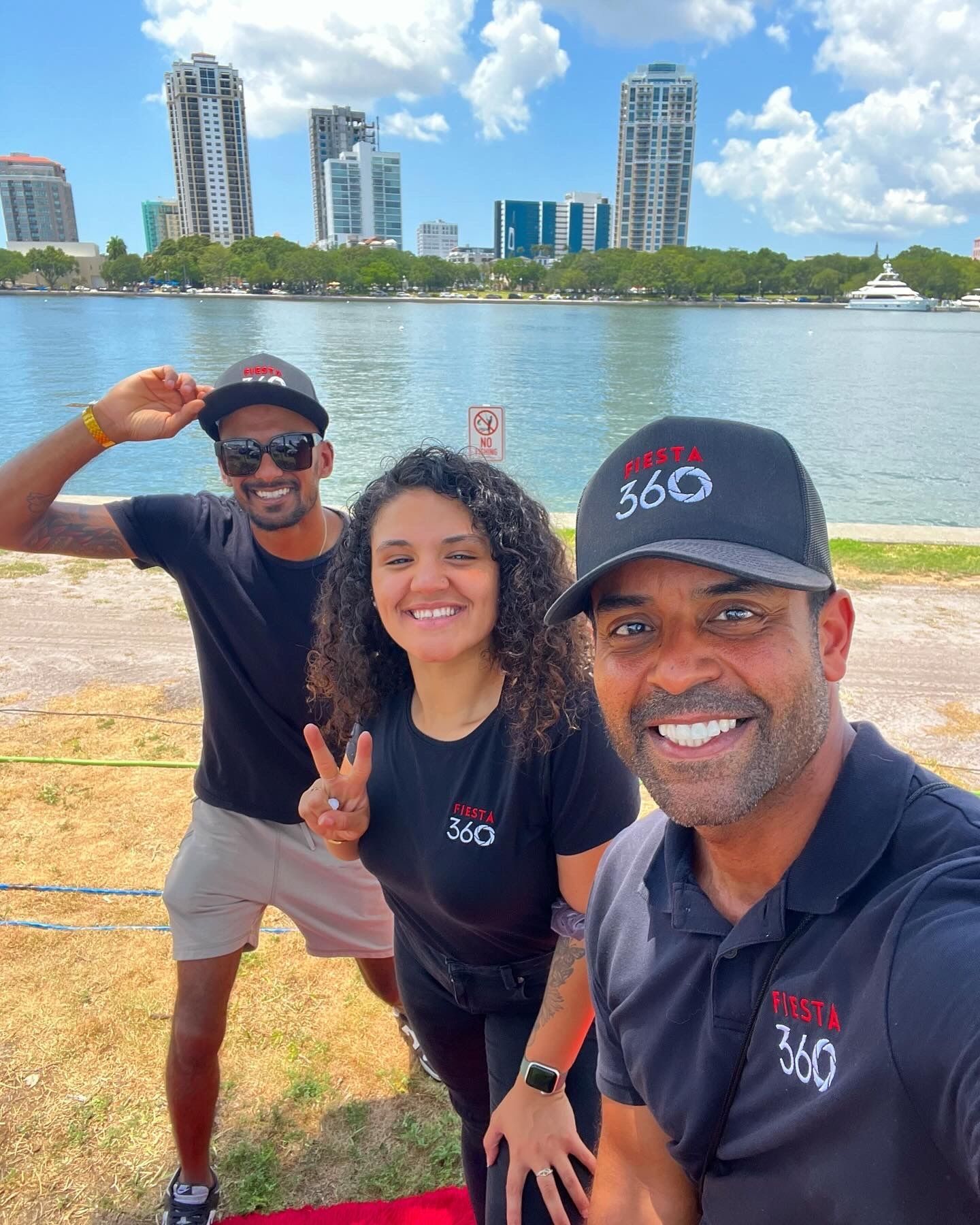 Fiesta 360 team taking selfie at Tampa event with skyline view