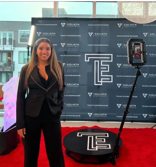 Fiesta 360 team member at Tampa corporate event backdrop