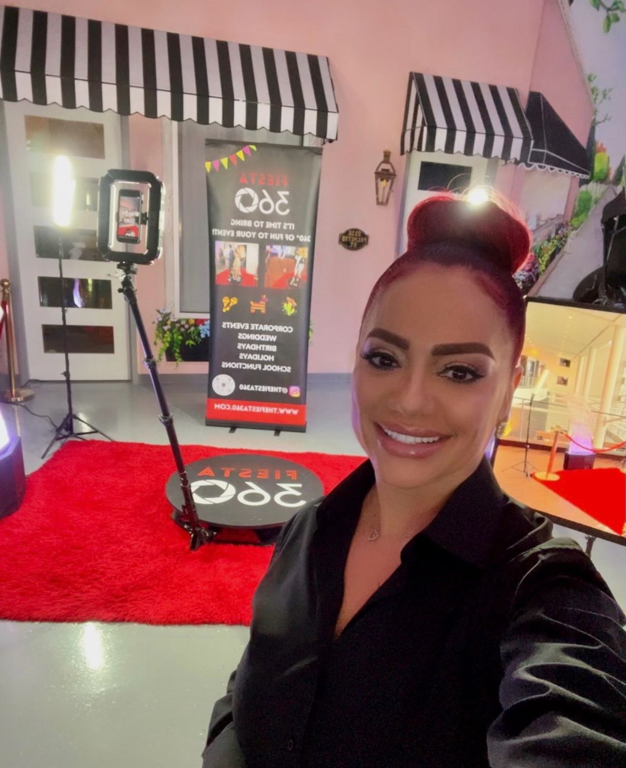 Fiesta 360 team member next to digital photo booth at Tampa event