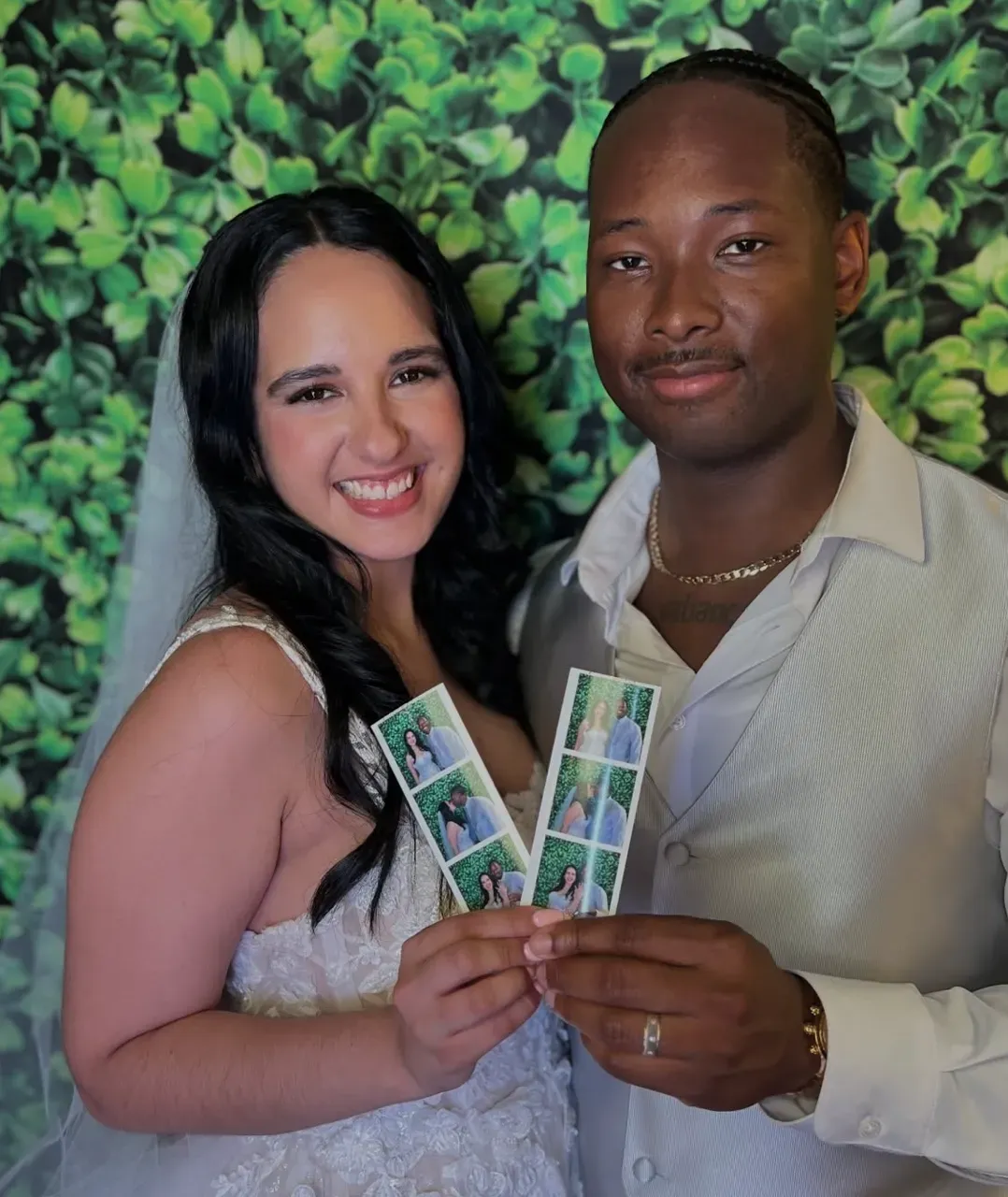 Couple smiling at Fiesta 360 wedding photo booth greenery backdrop Tampa