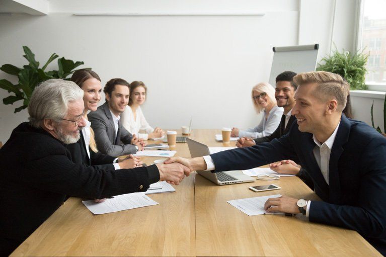 two employee discuss computer work